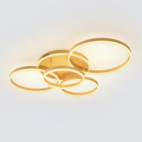 A sculptural gold dining room lighting fixture with five luminous rings, designed to create a warm, elegant glow above everyday gathering spaces.