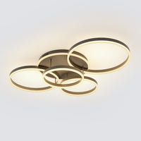 A black flush mount light with layered LED rings, balancing a strong modern profile with a soft, welcoming ceiling glow.