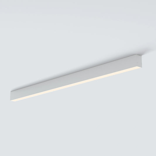 A modern linear LED ceiling light fixture in a sleek rectangular white housing, shown mounted on a plain light gray ceiling.