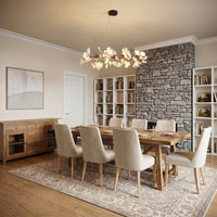 Gold linear ginkgo chandelier centered over a rectangular dining table in a contemporary room.