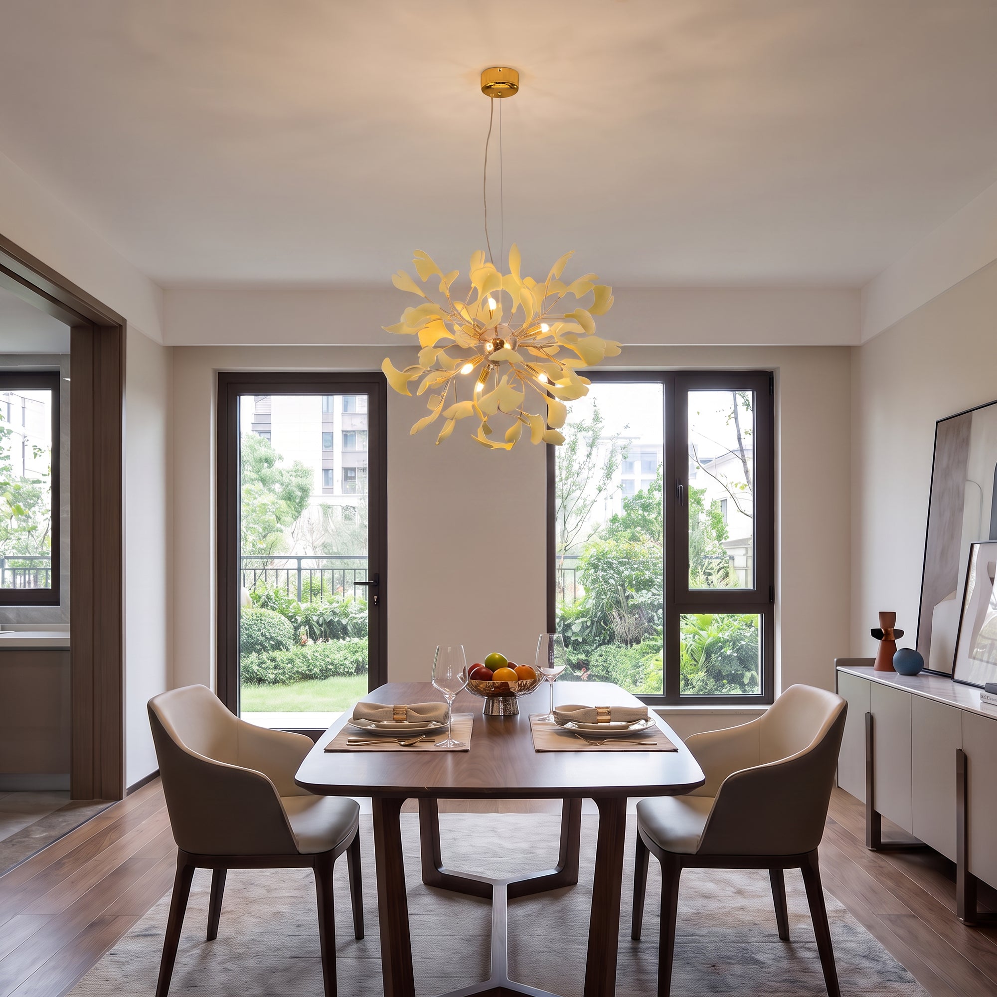 A modern dining room with a rectangular wooden table and four upholstered chairs, lit by a unique yellow flower-shaped chandelier hanging above the table.