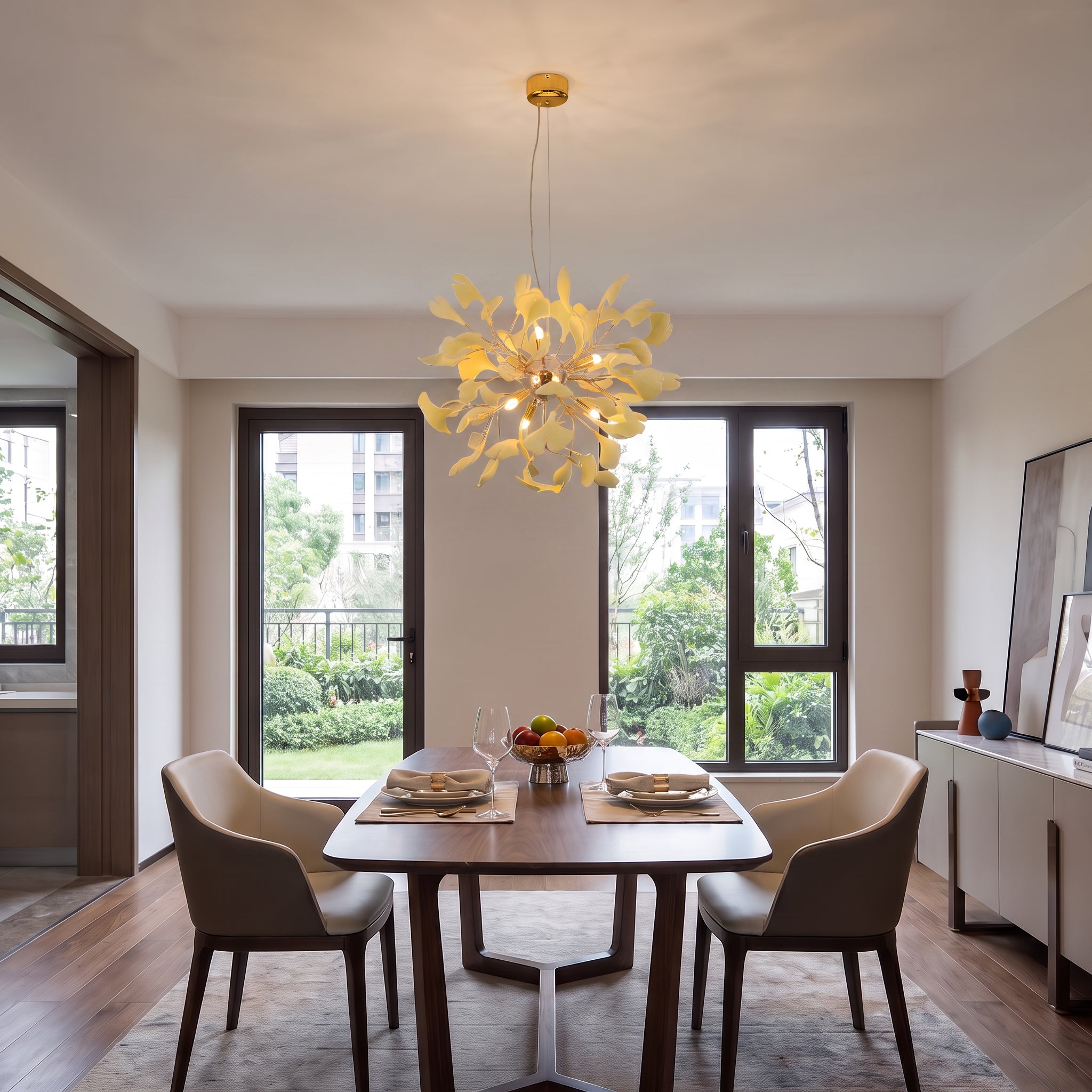 A modern dining room with a rectangular wooden table and four upholstered chairs, lit by a unique yellow flower-shaped chandelier hanging above the table.