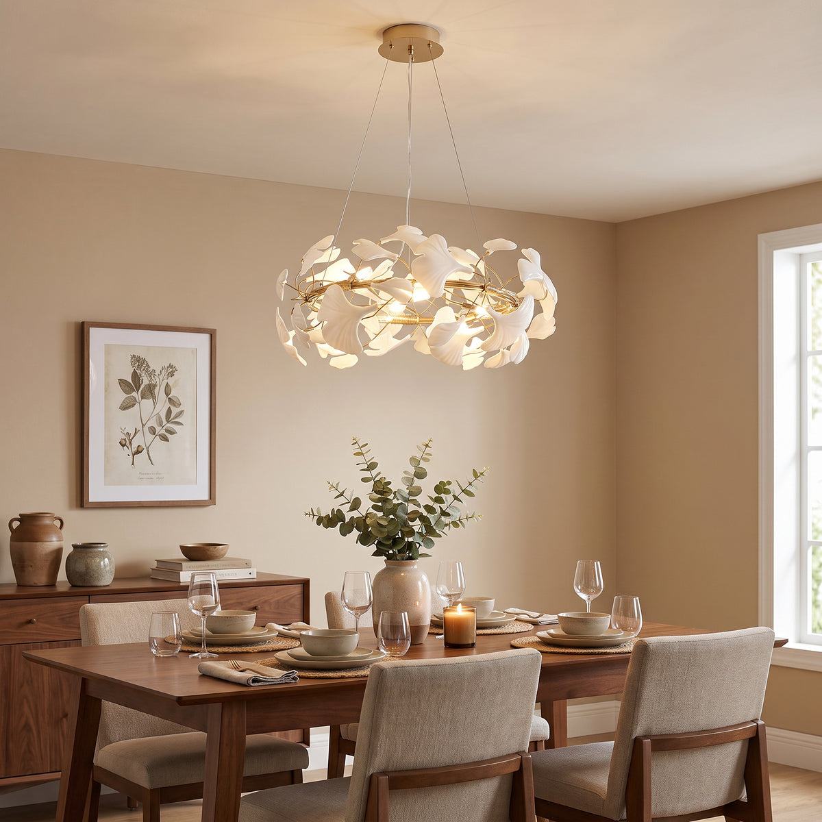 WM2419 chandelier glowing above a neutral dining table, with layered white ceramic leaves creating a calm focal point.